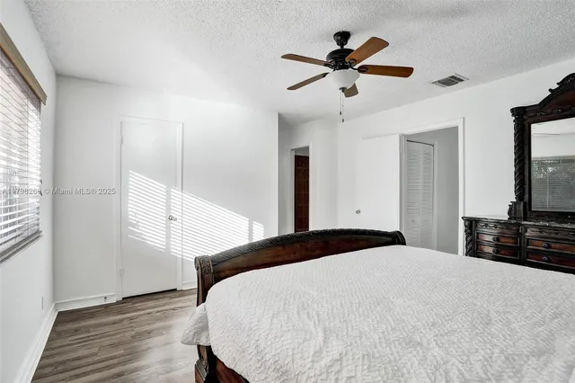 a bedroom with a bed and a large mirror