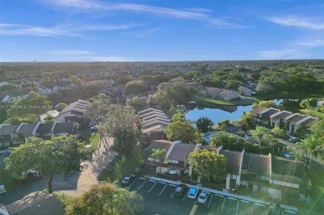 an aerial view of lake and residential houses with outdoor space