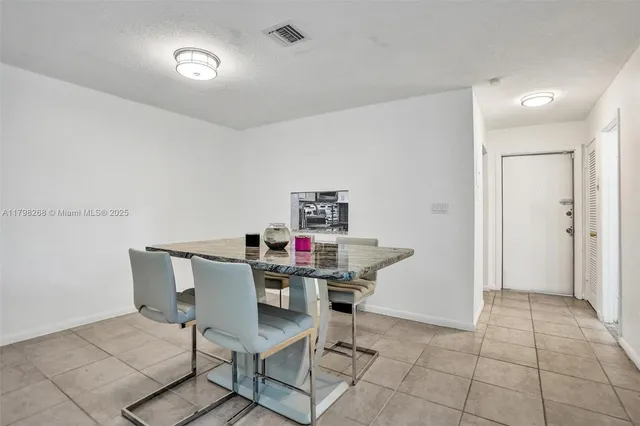 a view of a dining room with furniture and a chandelier fan