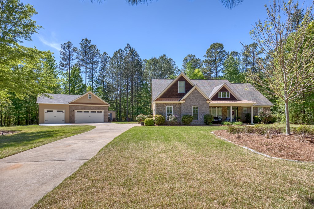 182 Oak Ridge Drive Waverly Hall, GA 31831 - Photo 4 of 67 a front view of a house with a yard and trees