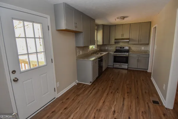 a kitchen with a sink stove and cabinets