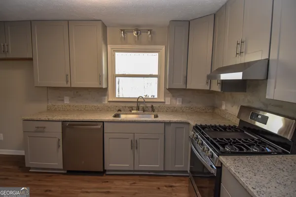 a view of a kitchen cabinets wooden floor and a window