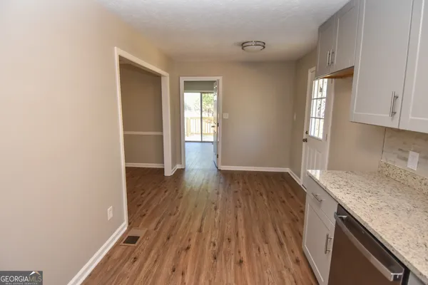 a kitchen with a sink stove and cabinets