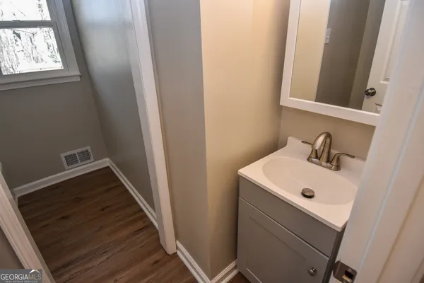 wooden floor in an empty room with a window