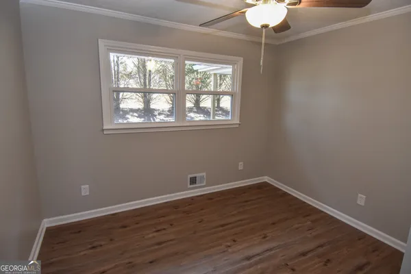 a bathroom with sink toilet and window