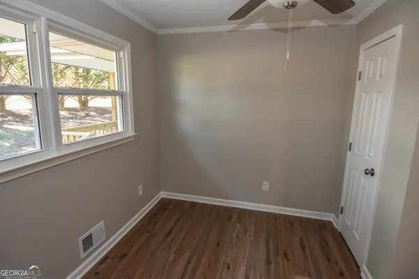 a balcony with wooden floor and fence