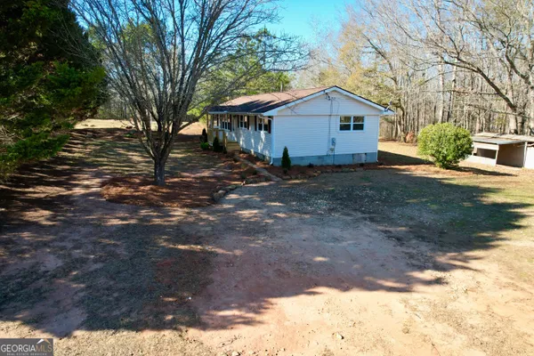 an aerial view of a house with a yard