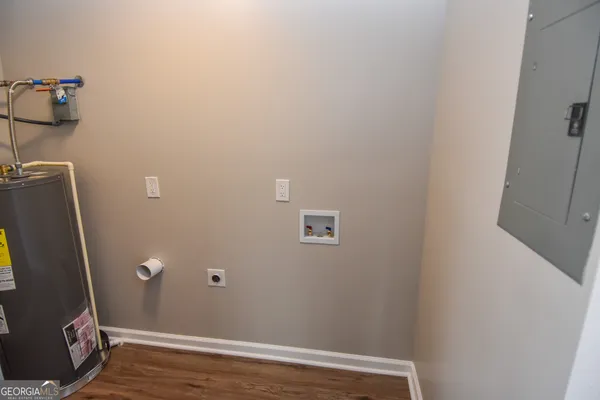 a view of an empty room and window and chandelier fan