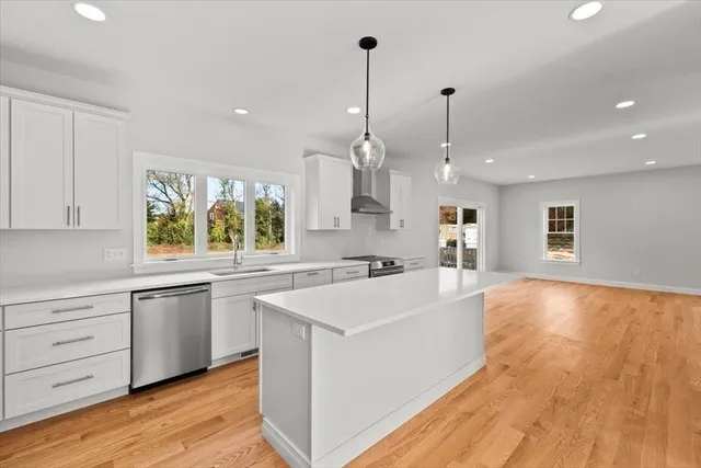 a view of a dining room with furniture and a chandelier fan