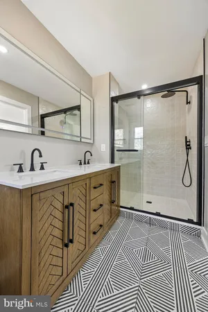 a bathroom with a sink a mirror and shower