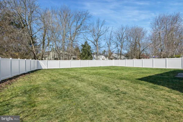 a view of yard with trees in the background