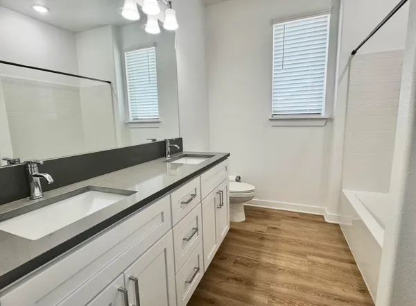 a view of an empty room with closet and a window