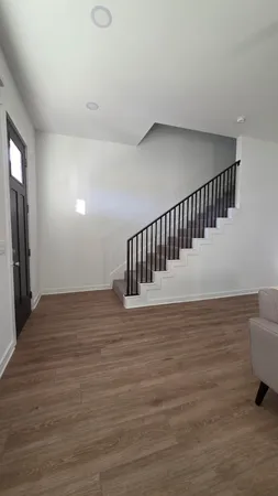 a view of hallway with wooden floor