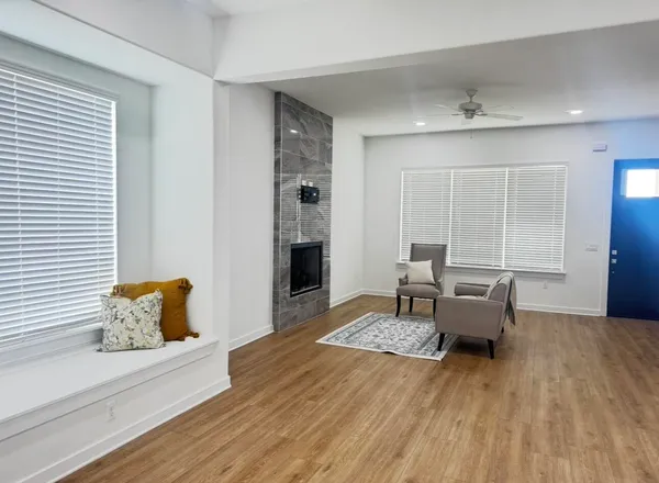 a living room with furniture and a wooden floor
