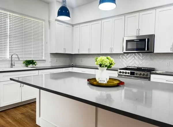 a kitchen with a stove a sink and a microwave