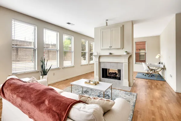 a living room with furniture and a fireplace