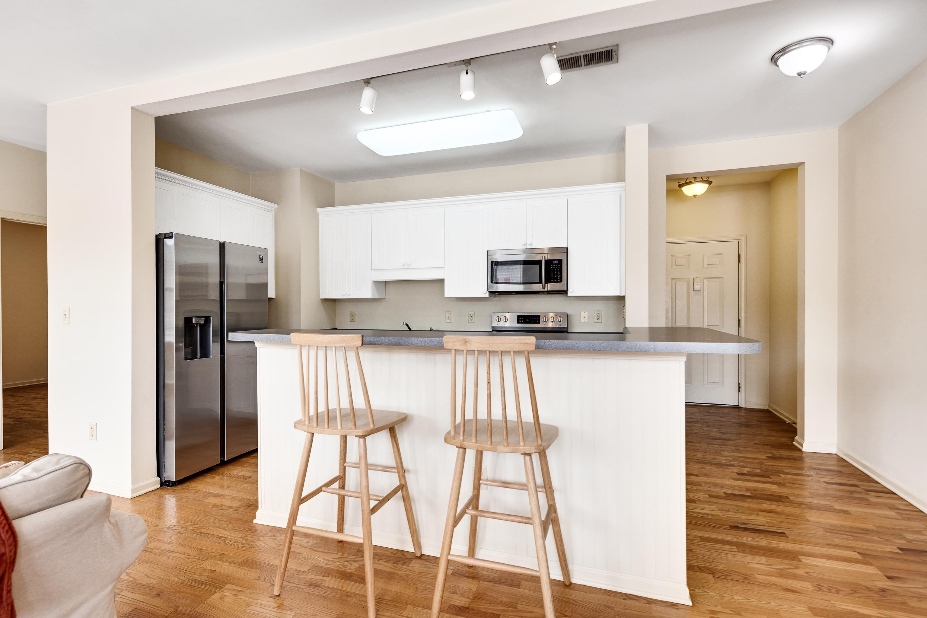 600 South Main Street, Unit 101 Memphis, TN 38103 - Photo 11 of 35 a kitchen with stainless steel appliances kitchen island granite countertop a refrigerator and microwave