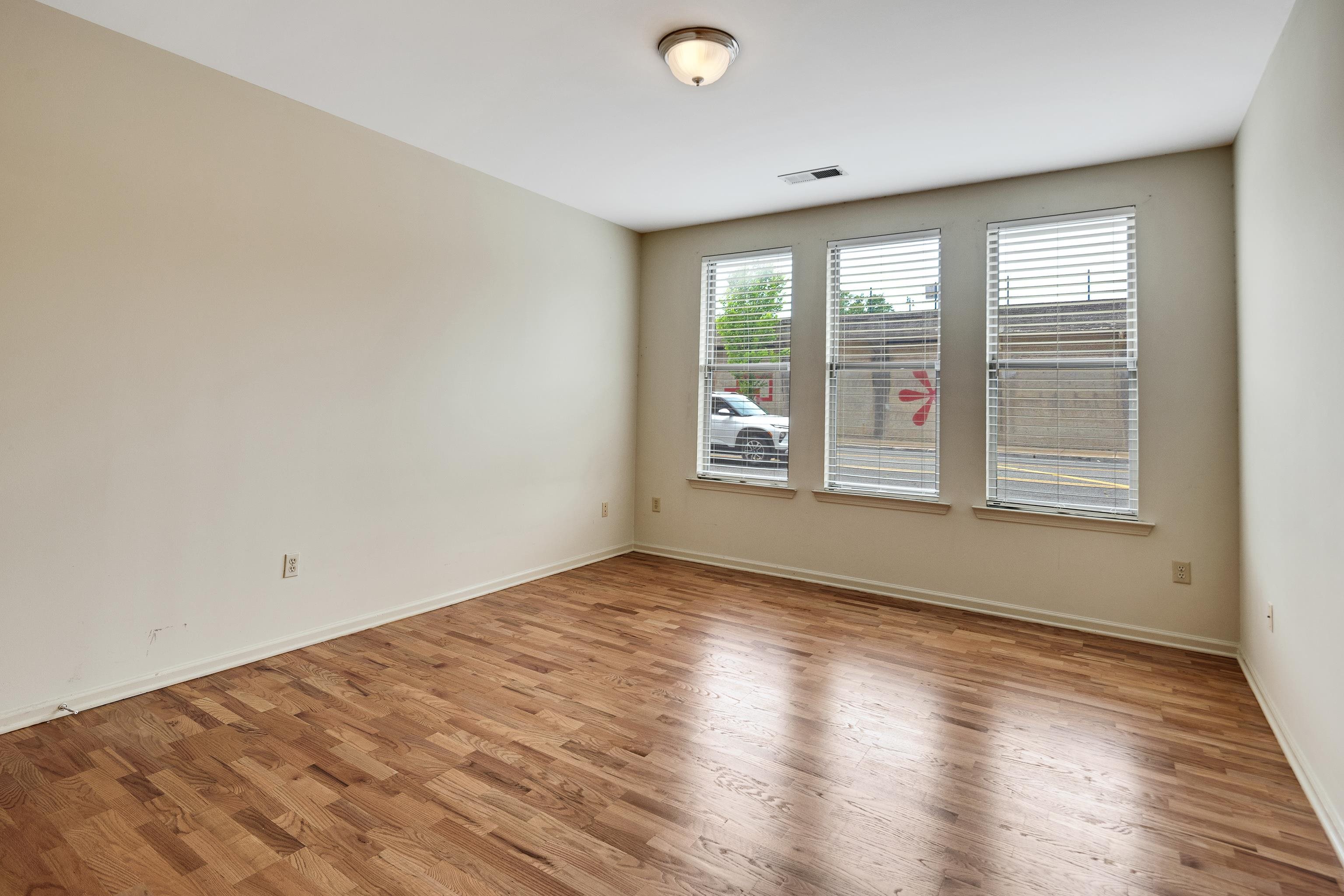 600 South Main Street, Unit 101 Memphis, TN 38103 - Photo 22 of 35 a view of an empty room with wooden floor and a window