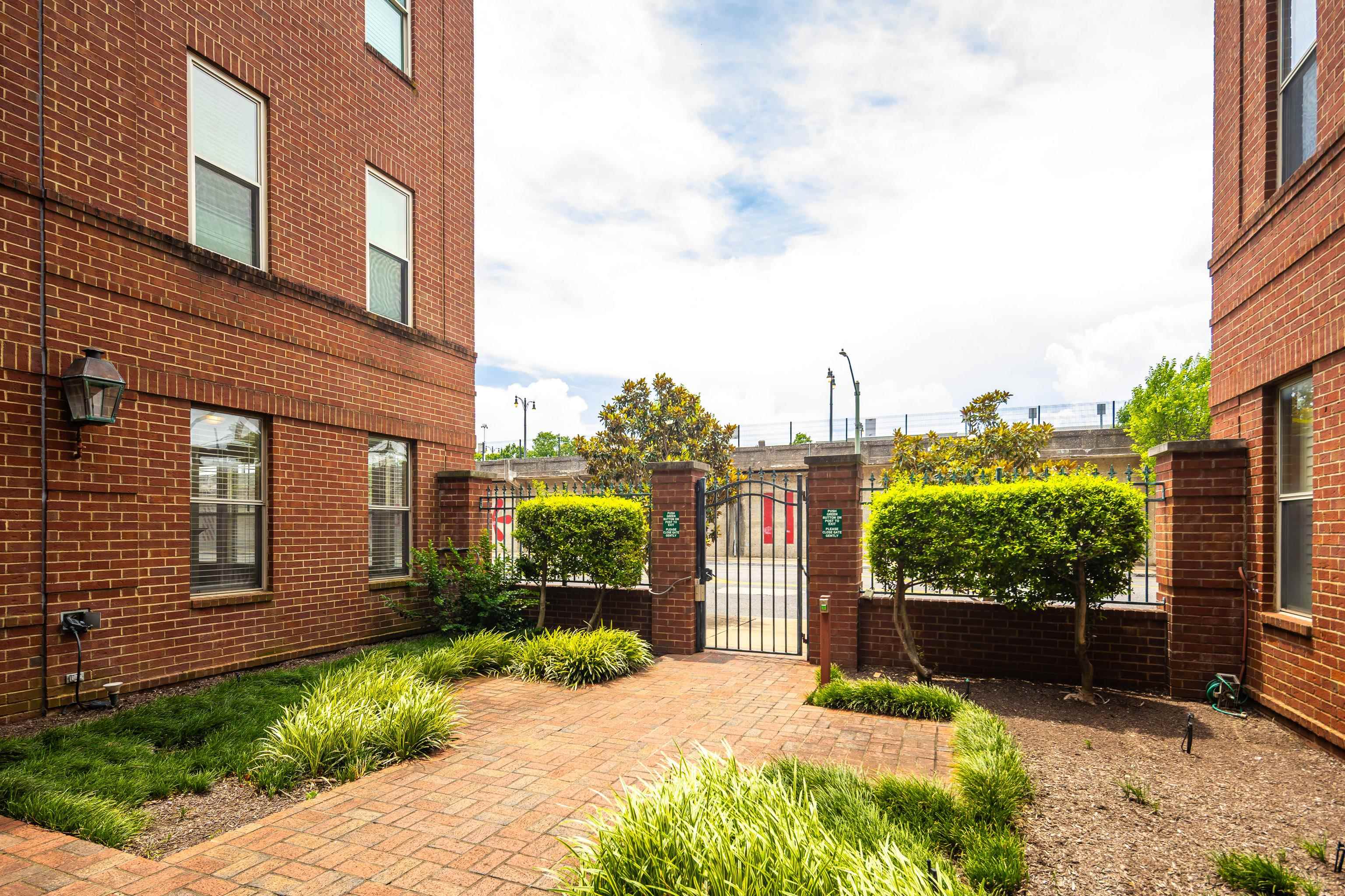600 South Main Street, Unit 101 Memphis, TN 38103 - Photo 4 of 35 a front view of a house with a yard and potted plants