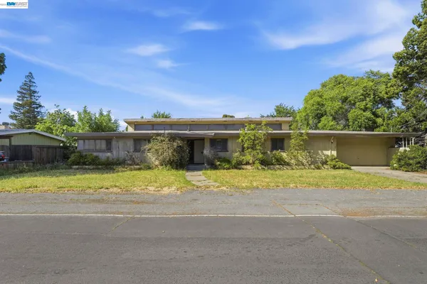 a front view of a house with a garden