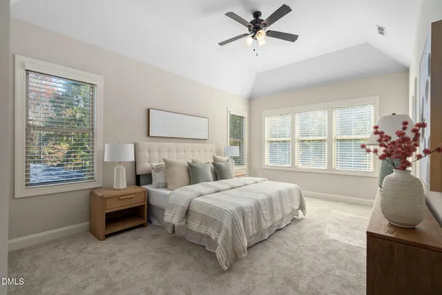 a bedroom with a bed a couch and a window