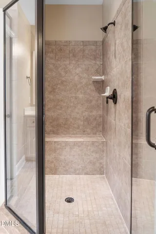 a spacious bedroom with a large bed a rug and potted plant