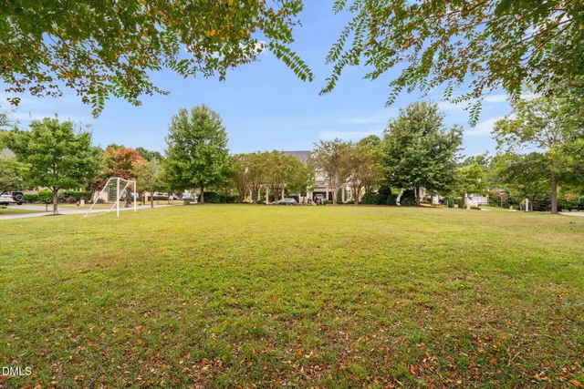 a view of yard with swimming pool and trees