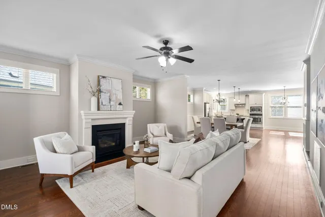 a living room with furniture fireplace and wooden floor