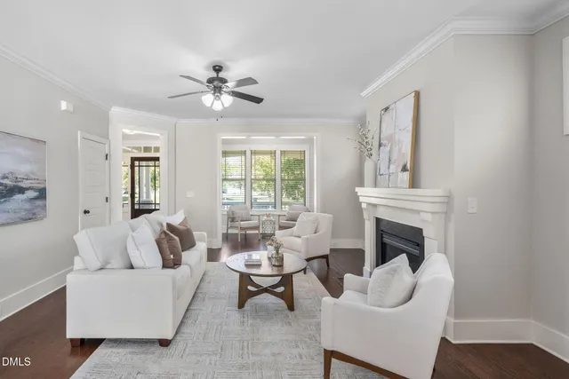 a spacious bedroom with a bed a chandelier and large window