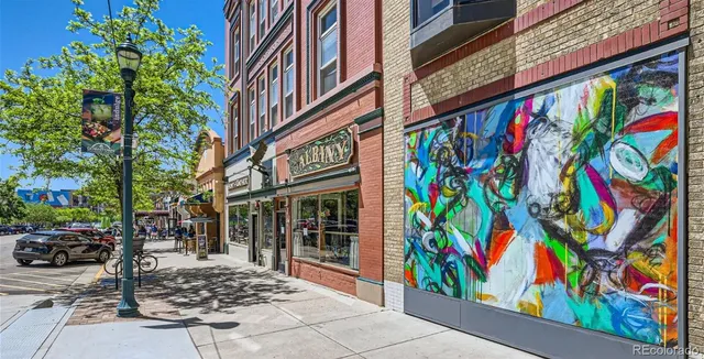 a view of a street with a bench and trees