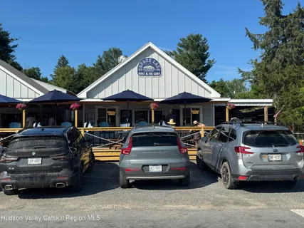 a dining room with furniture window and wooden floor