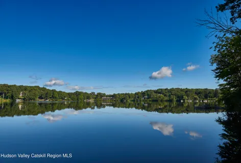an aerial view of a house with a yard and outdoor seating