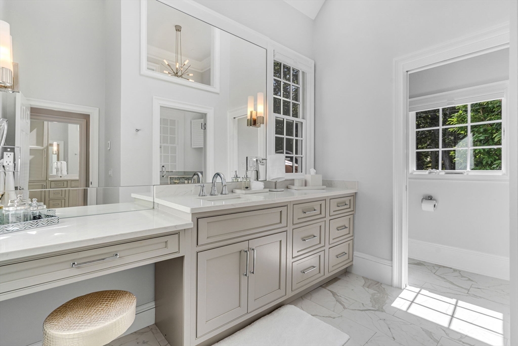 295 Musterfield Road Concord, MA 01742 - Photo 23 of 40 a spacious bathroom with a granite countertop double vanity sink a mirror and a shower
