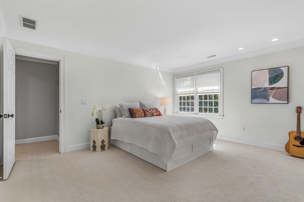 295 Musterfield Road Concord, MA 01742 - Photo 31 of 40 a spacious bedroom with a bed and a window