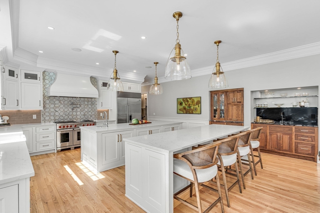 295 Musterfield Road Concord, MA 01742 - Photo 8 of 40 a large kitchen with kitchen island a counter space a sink and appliances