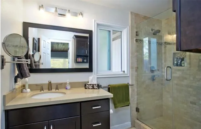 a spacious bedroom with a large bed couch and window