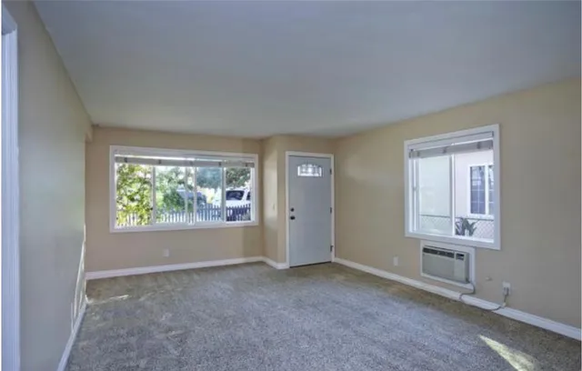 a view of a chairs and table in patio with a barbeque