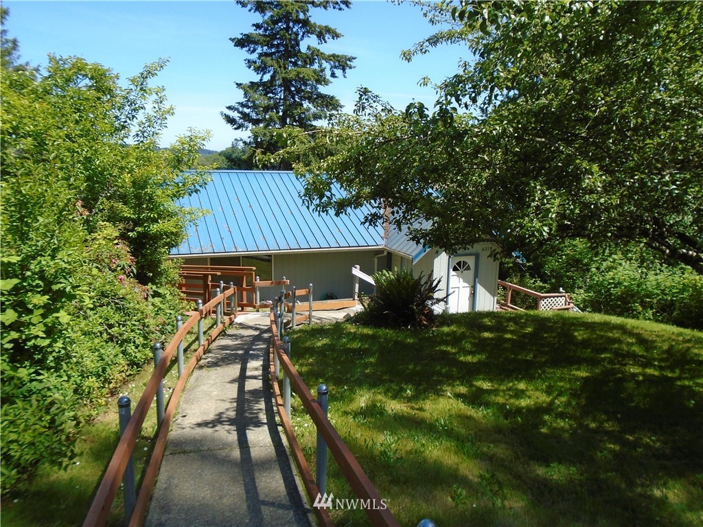 6219 Yeazell Road Southwest Longbranch, WA 98351 - Photo 2 of 27 a front view of house with yard and trees