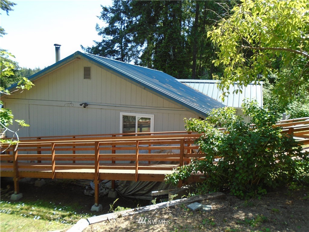 6219 Yeazell Road Southwest Longbranch, WA 98351 - Photo 24 of 27 a view of a house with a backyard