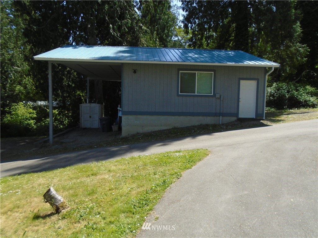 6219 Yeazell Road Southwest Longbranch, WA 98351 - Photo 25 of 27 a view of a house with backyard tub and garden