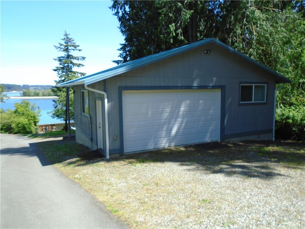 6219 Yeazell Road Southwest Longbranch, WA 98351 - Photo 26 of 27 a house with a yard
