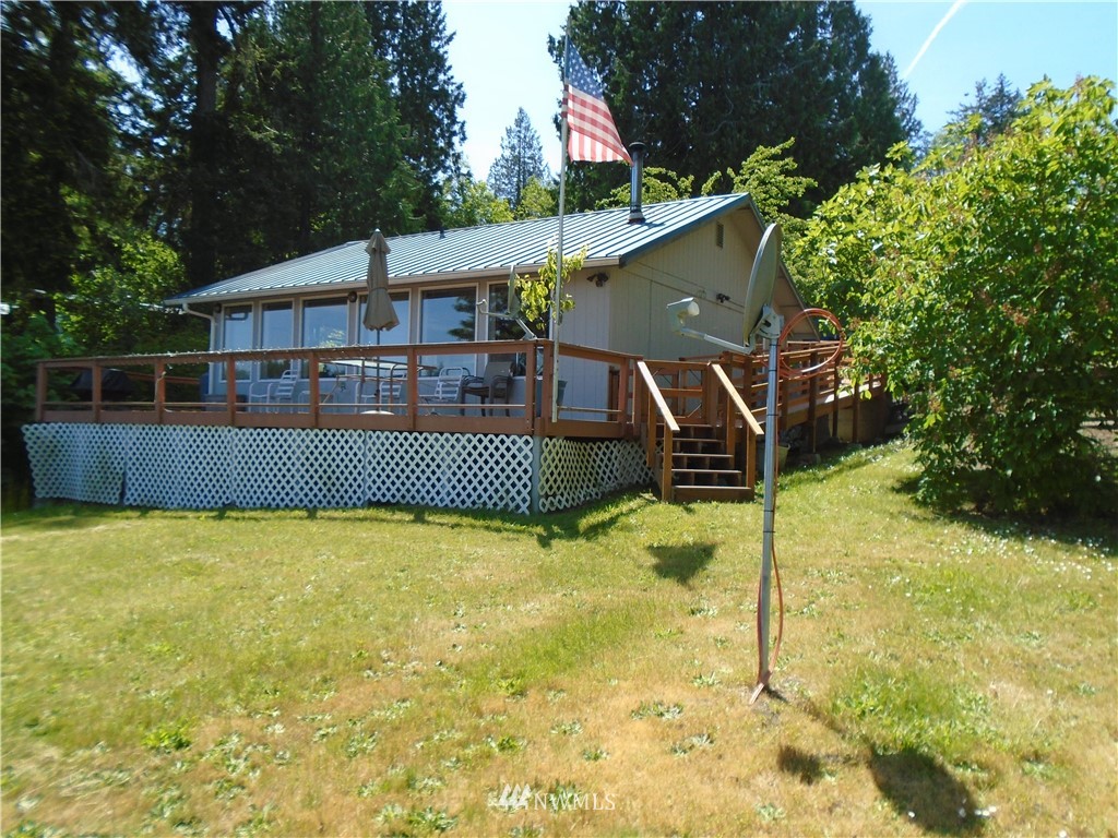 6219 Yeazell Road Southwest Longbranch, WA 98351 - Photo 4 of 27 a view of a house with a backyard