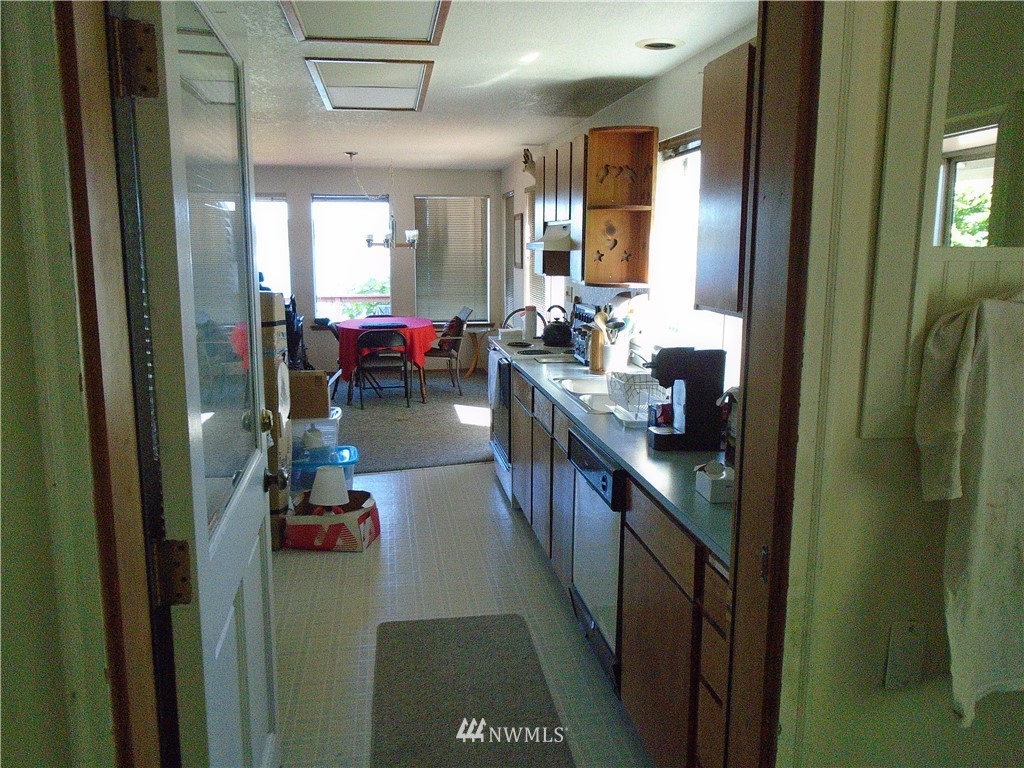 6219 Yeazell Road Southwest Longbranch, WA 98351 - Photo 6 of 27 a kitchen with counter top space and living room