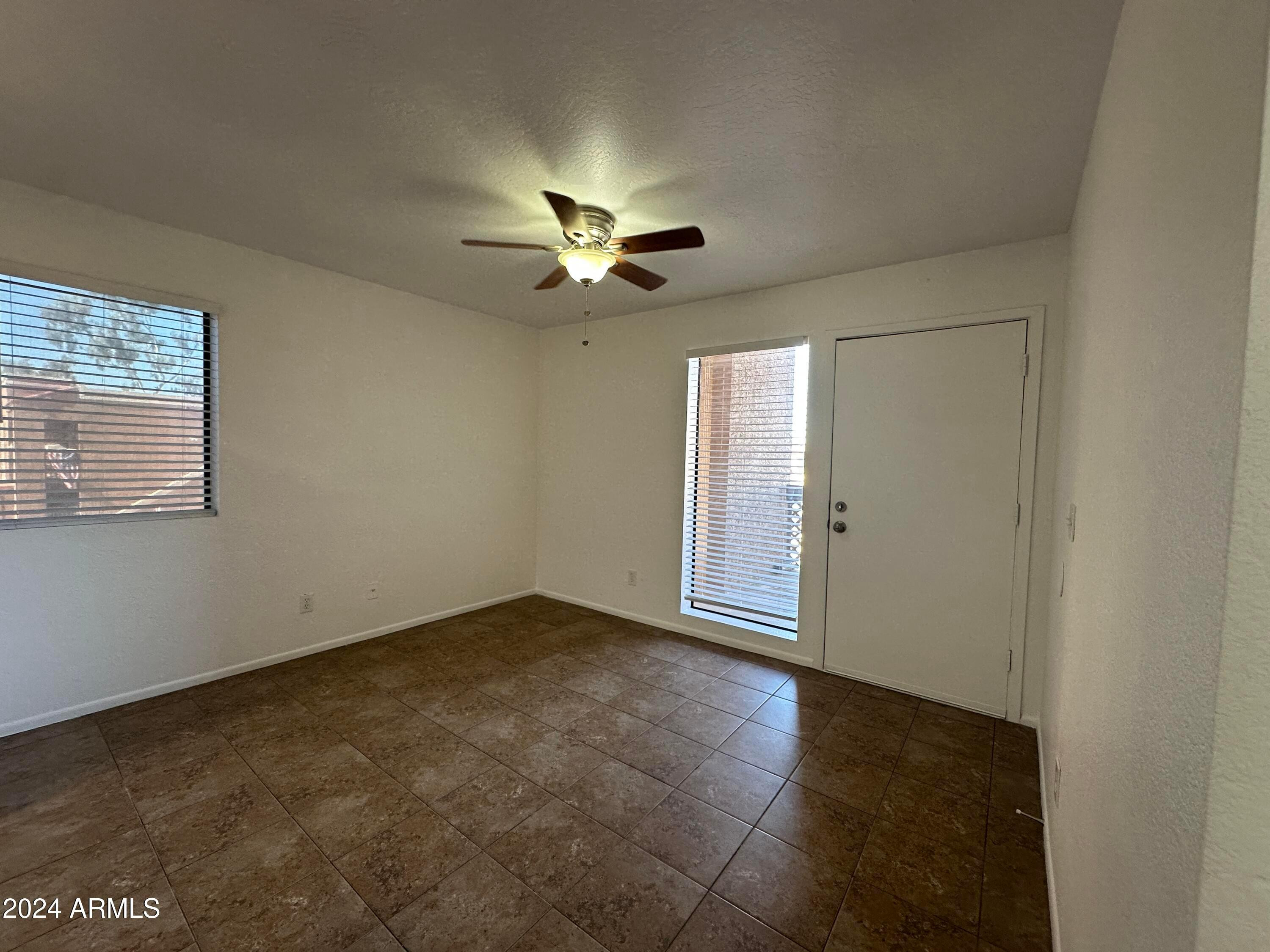 2650 East McKellips Road, Unit 204 Mesa, AZ 85213 - Photo 11 of 13 an empty room with fan and windows