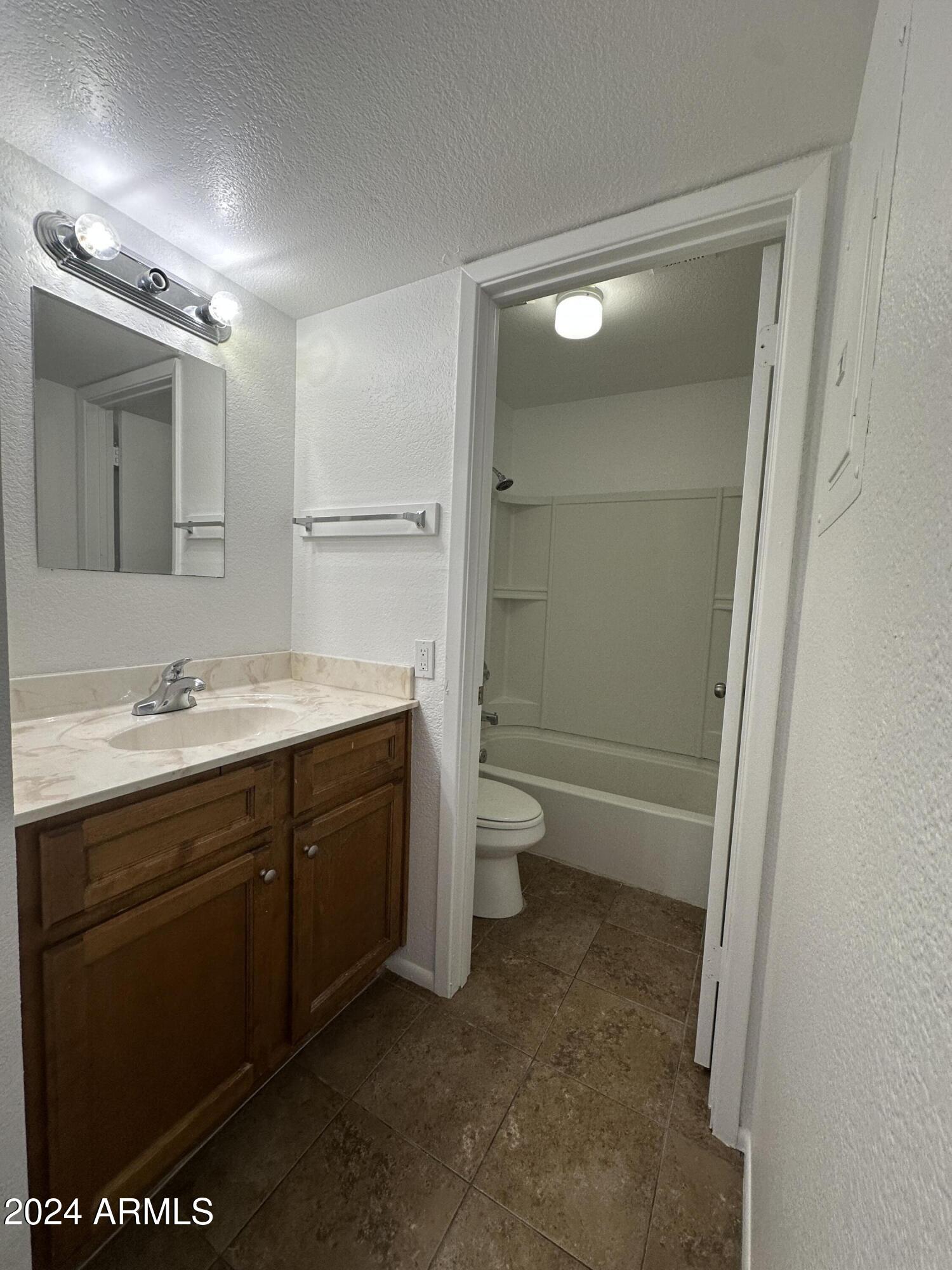 2650 East McKellips Road, Unit 204 Mesa, AZ 85213 - Photo 8 of 13 a bathroom with a sink a toilet and shower