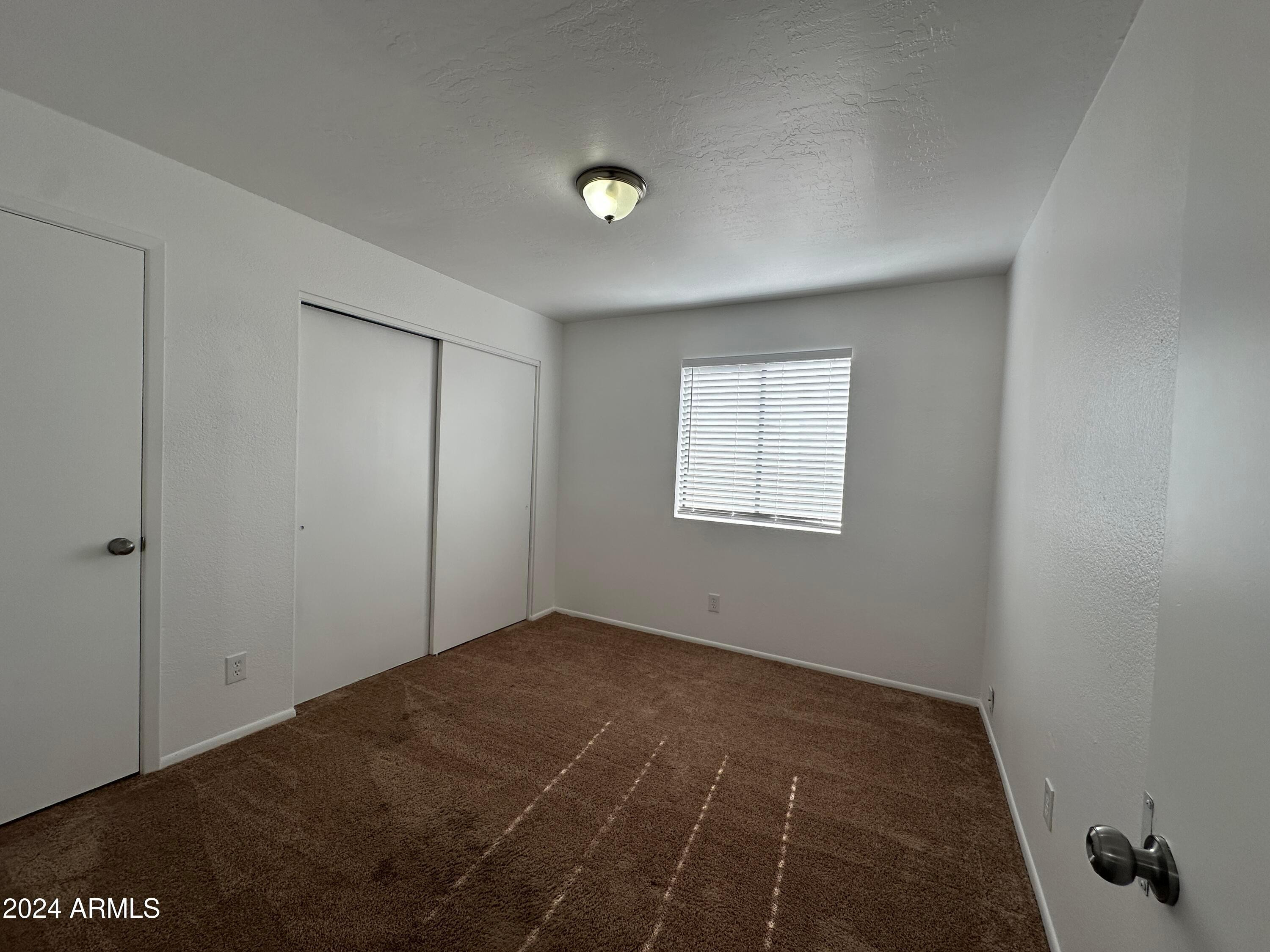 2650 East McKellips Road, Unit 204 Mesa, AZ 85213 - Photo 9 of 13 a view of an empty room with a window