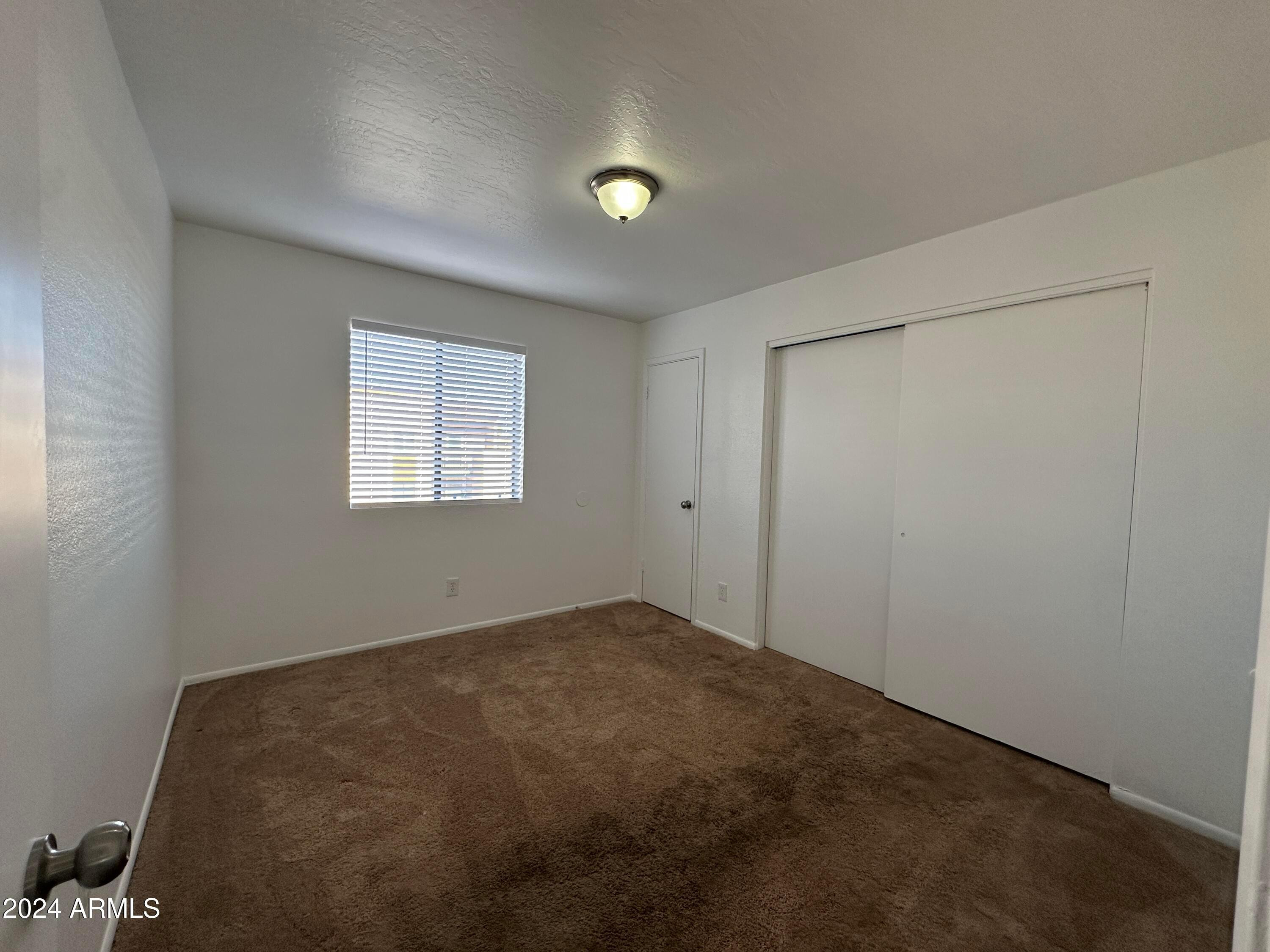 2650 East McKellips Road, Unit 204 Mesa, AZ 85213 - Photo 10 of 13 a view of an empty room with a window