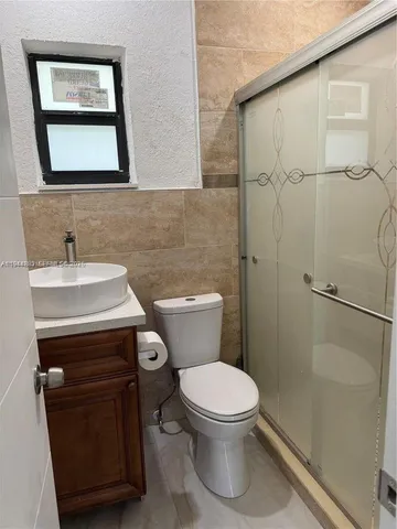 a bathroom with a toilet sink and shower