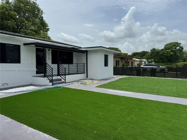 a house view with swimming pool in front of it