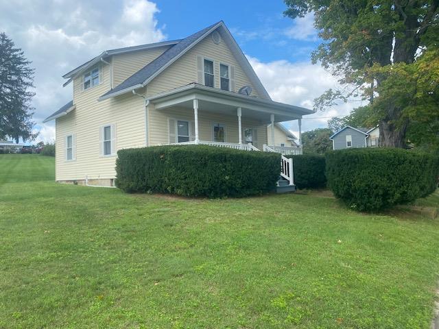 1007 Perryville Road Parker, PA 16049 - Photo 1 of 20 a front view of a house with a garden